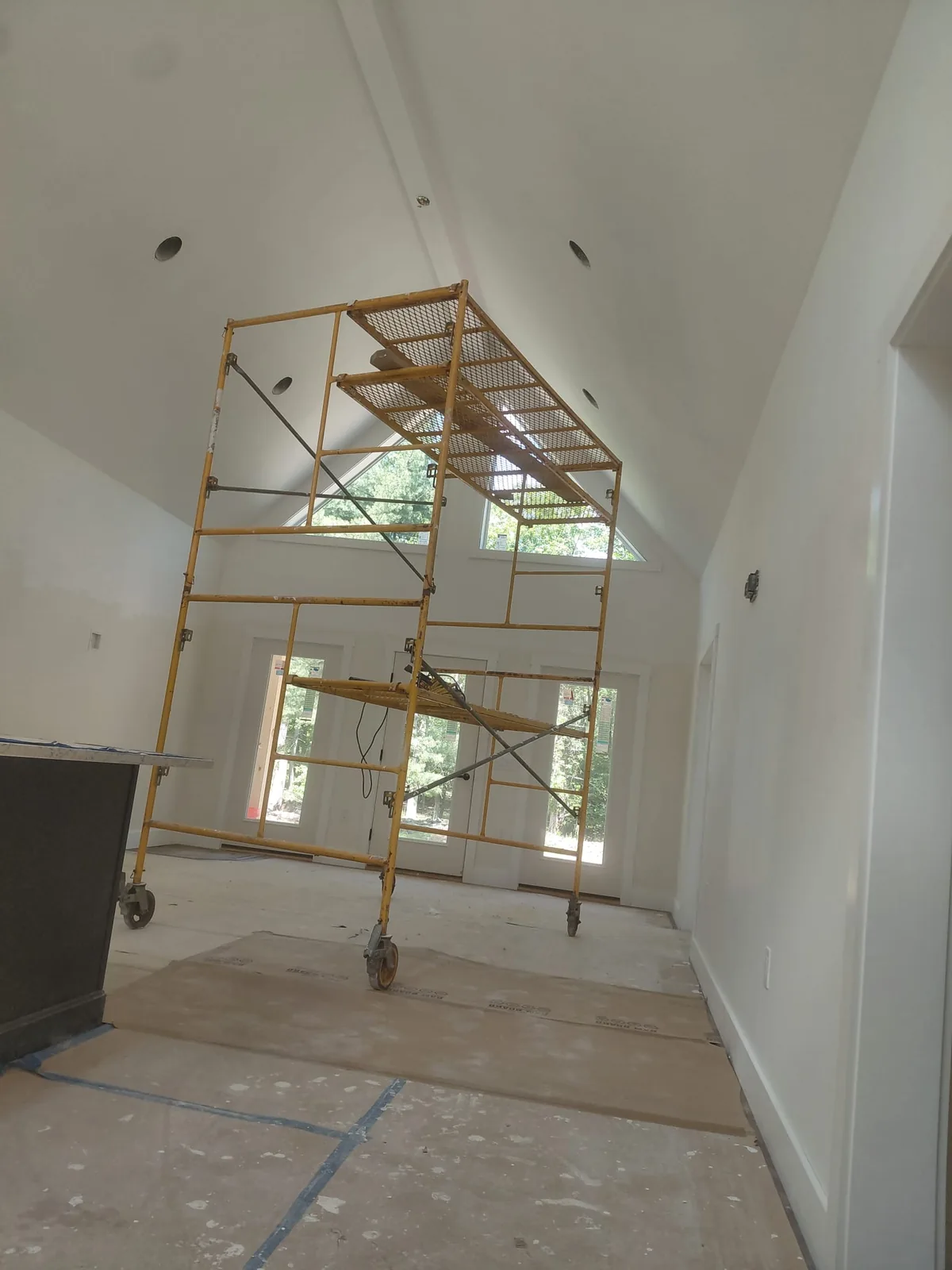 Vaulted great room painted bright white with clean lines