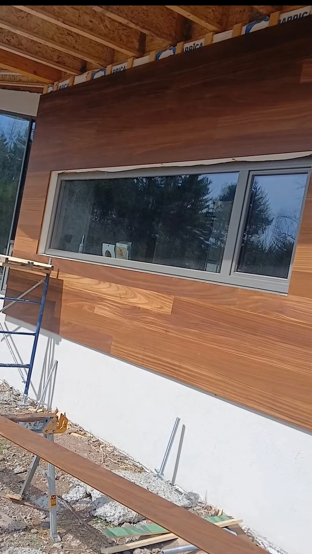 Modern wood siding installed above a stucco base